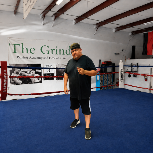 Coach Joe standing inside The Grind Boxing Academy ring