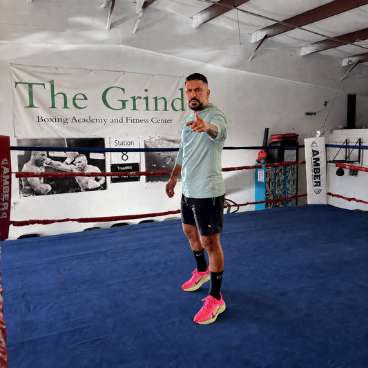 Coach Manny standing inside The Grind Boxing Academy ring