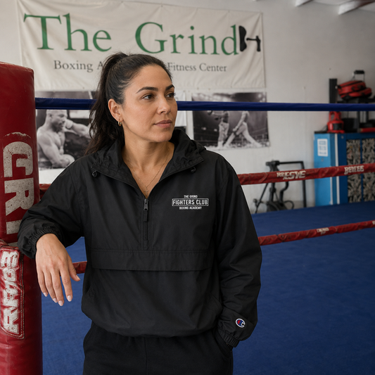 Model wearing The Grind Fighters Club Champion jacket inside The Grind gym