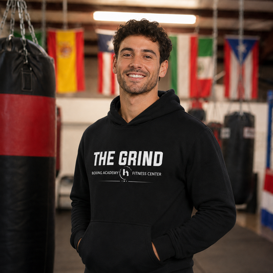 Male model wearing The Grind Boxing Academy hoodie inside The Grind gym