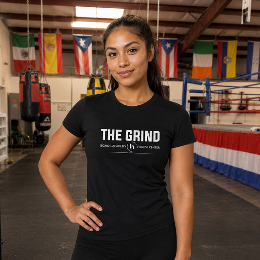 Model wearing The Grind women’s logo T-shirt inside The Grind gym