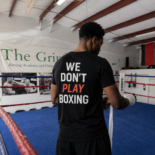 Model wearing We Don't Play Boxing T-shirt inside The Grind gym